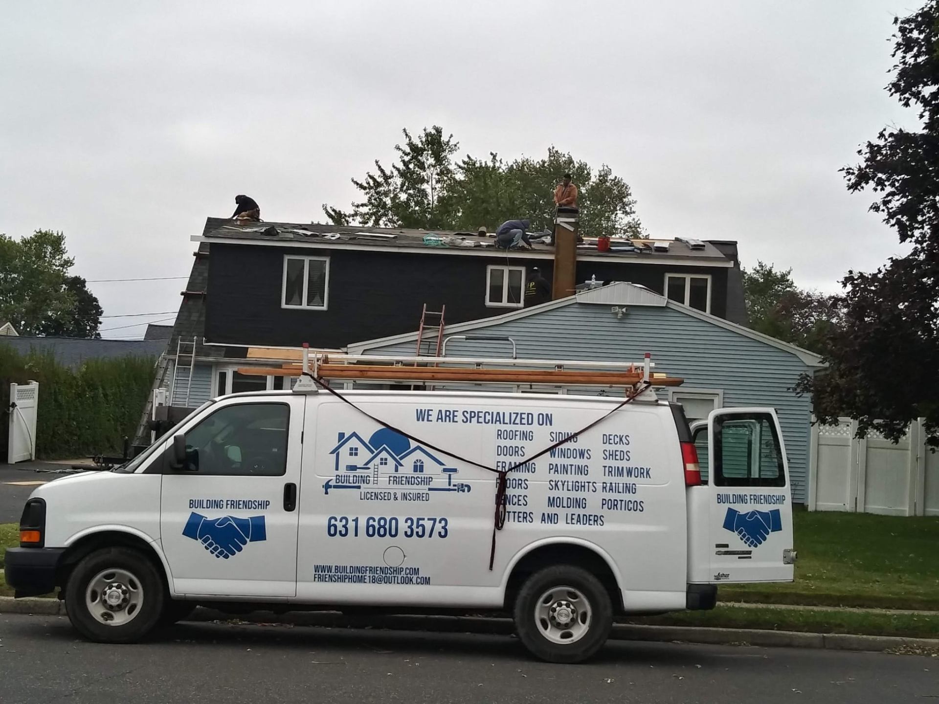 Work van at a residential roofing job site