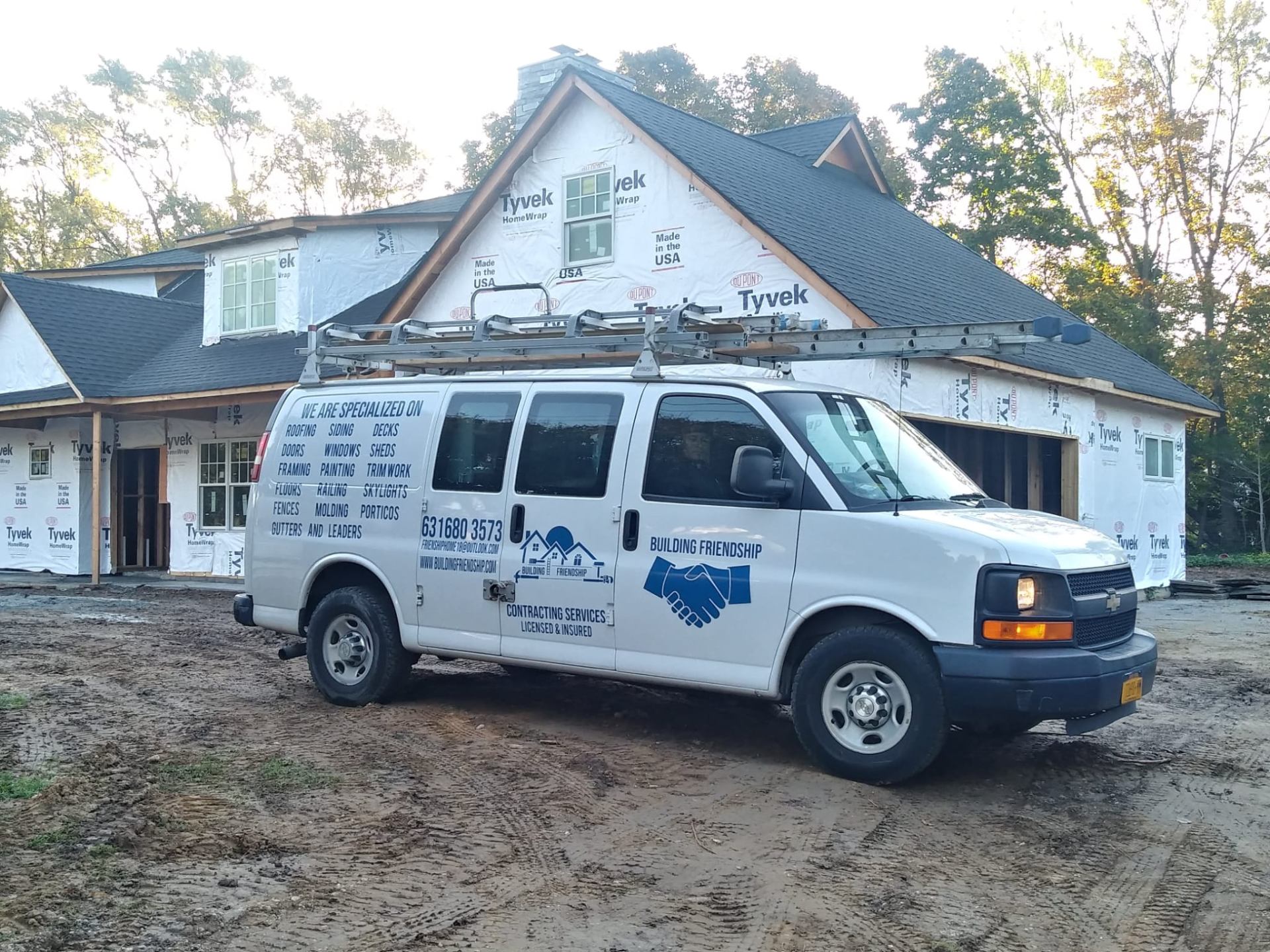 New construction home with a completed shingle roof and house wrap
