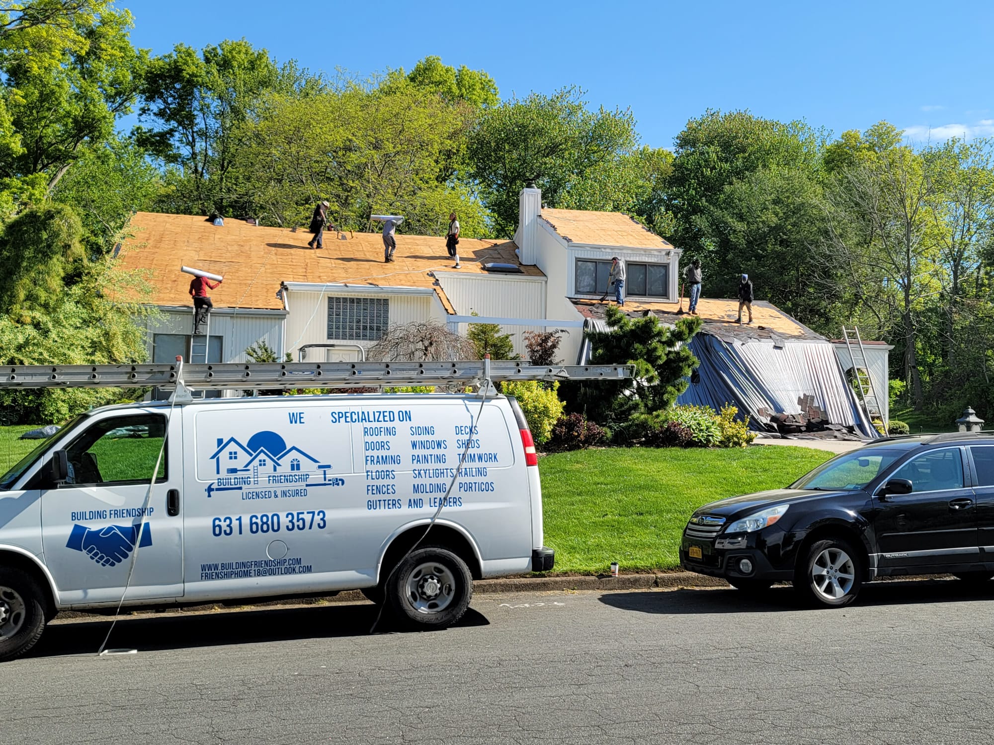 Crew on site performing a roof tear-off