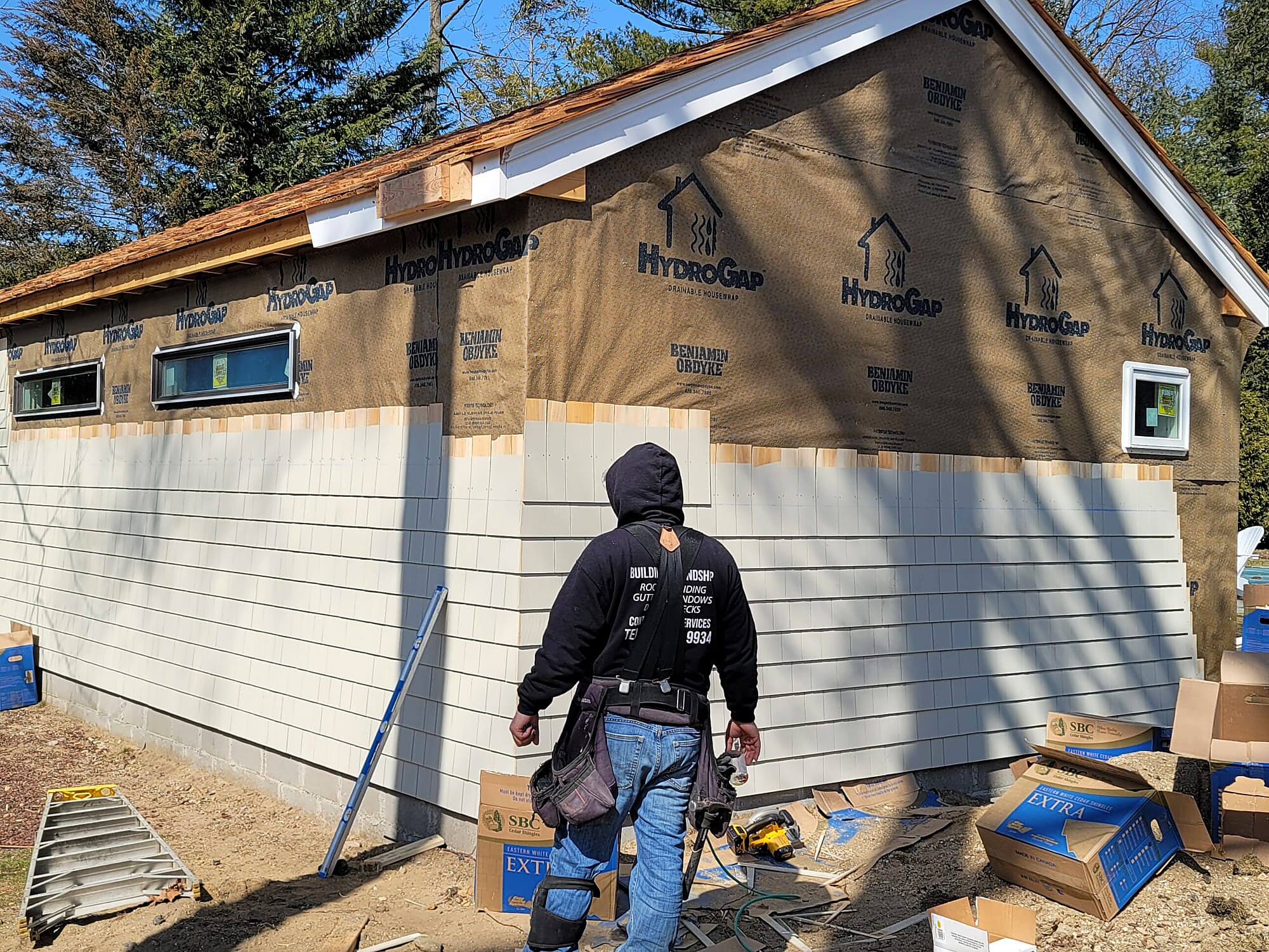 Siding installation with house wrap visible