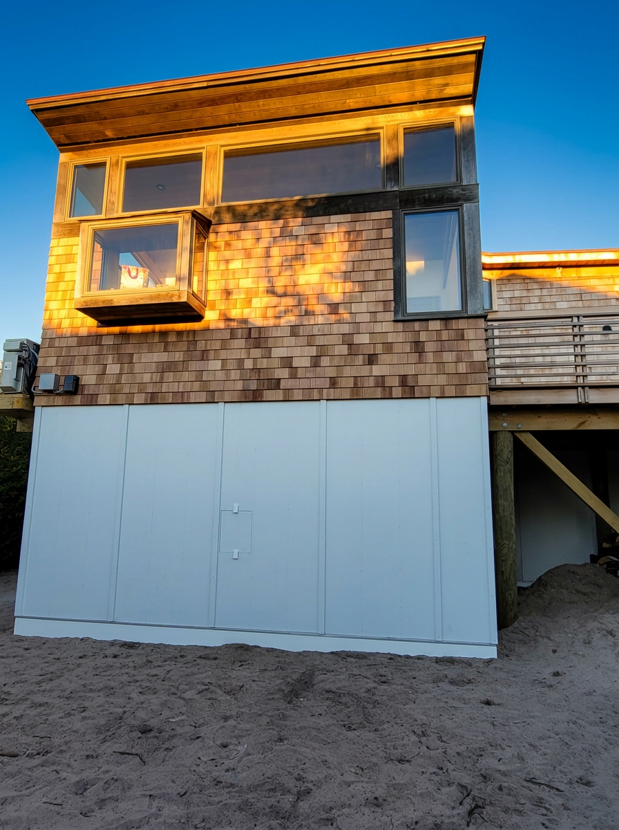 Modern beach house with cedar shake siding at golden hour