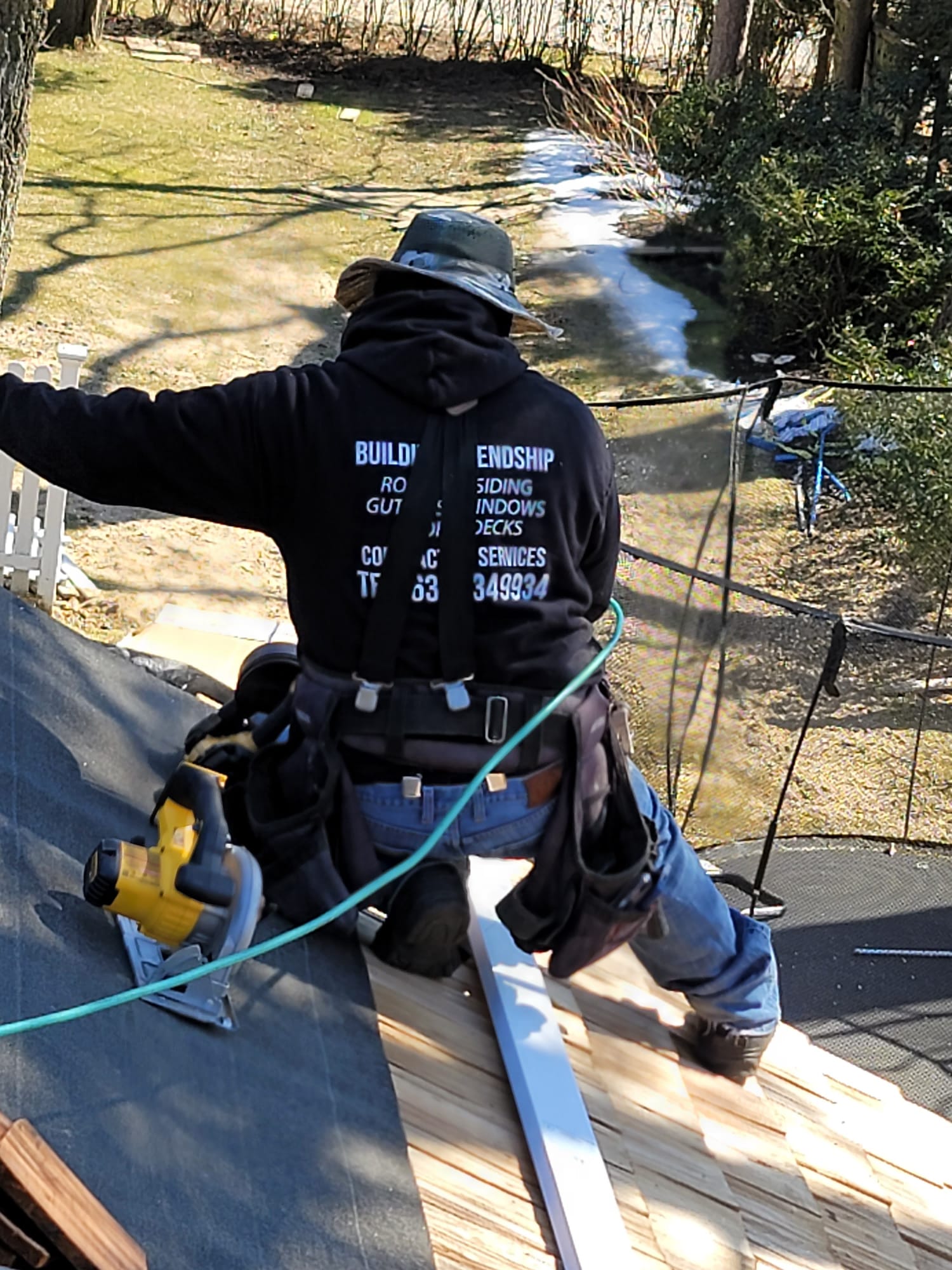 Roofing crew working on a residential roof replacement